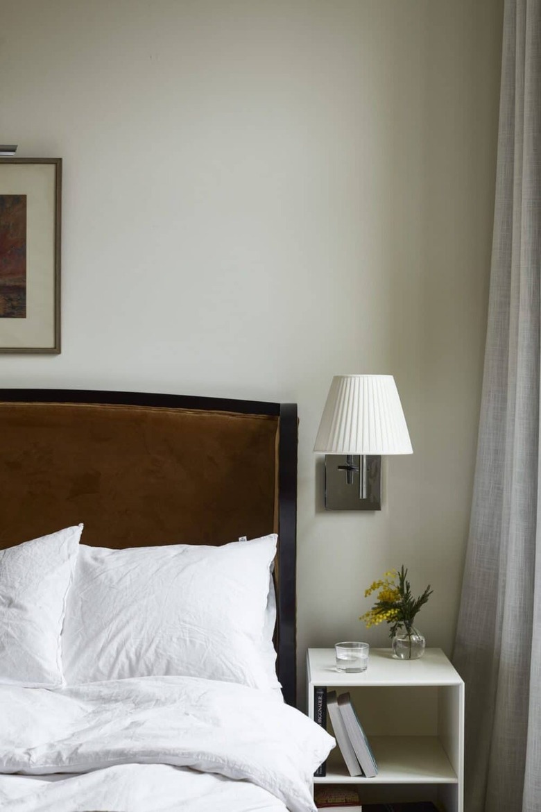 bed with simple shelf beside it