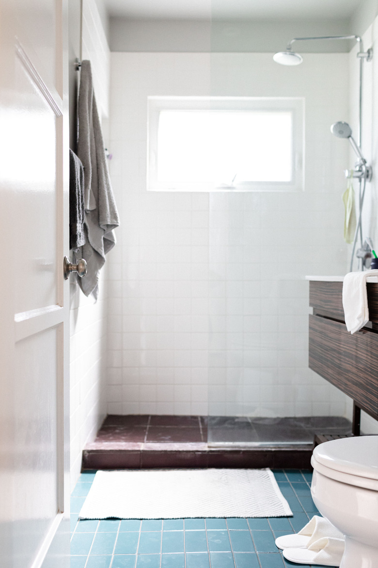 open shower; toilet and bathroom vanity in the picture