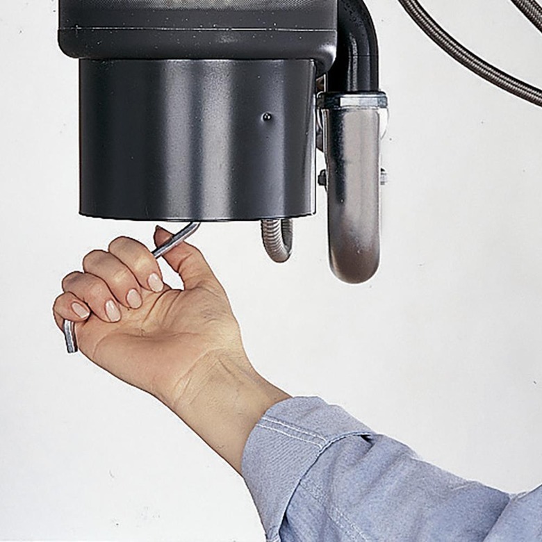 Cranking disposal with a wrench.