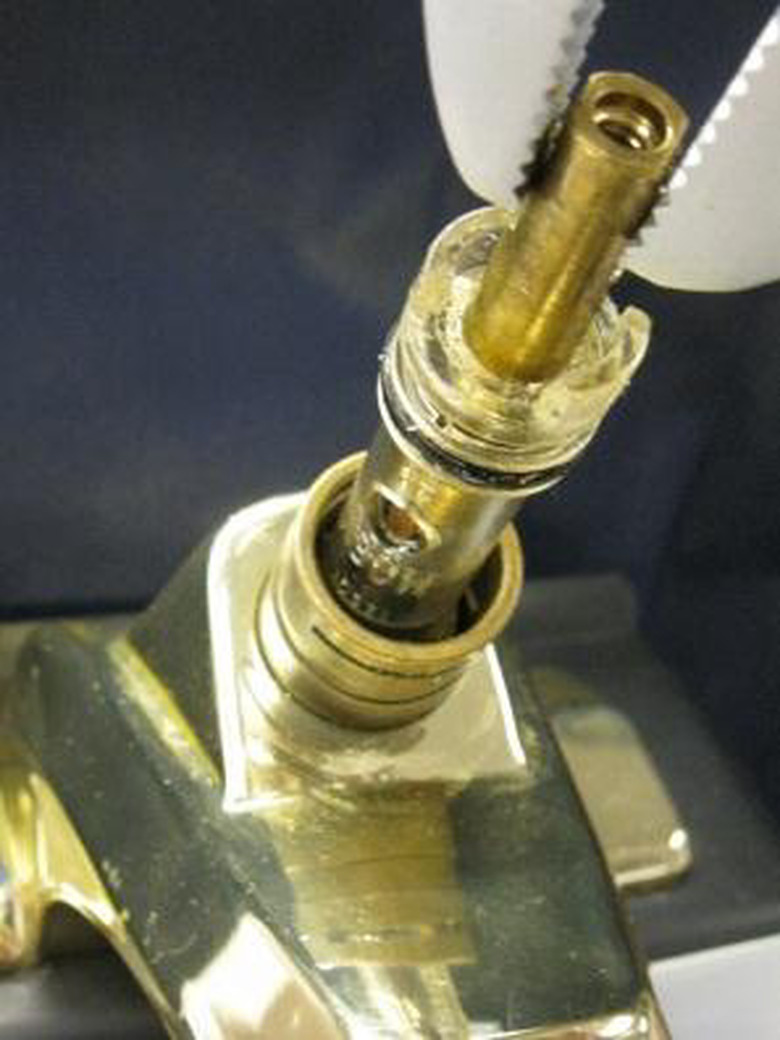 Disassembling a Moen faucet.