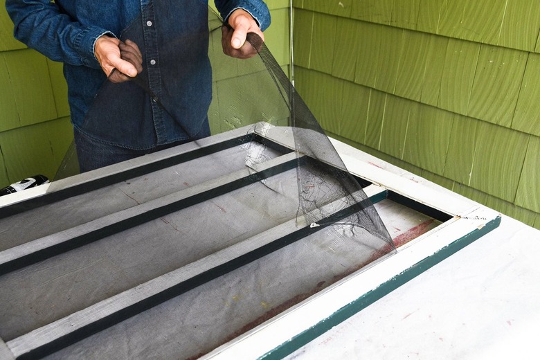 pulling screen door mesh from door