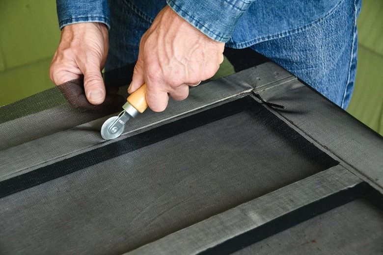 preparing screen door mesh with spline roller