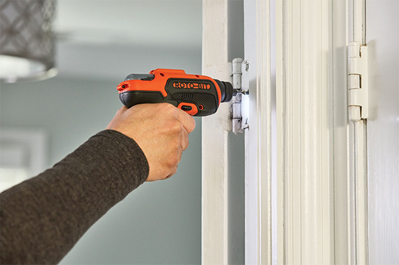 Installing hinge screws.