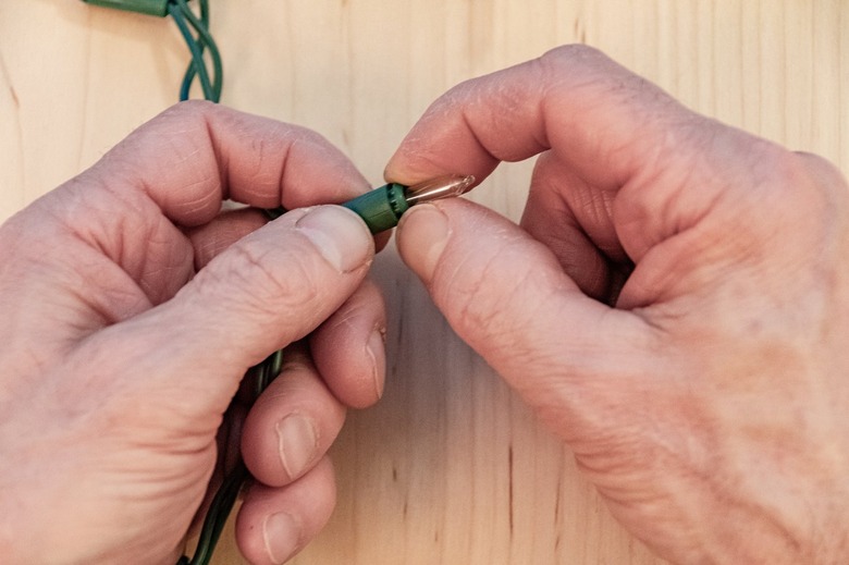 installing bulb into string light socket