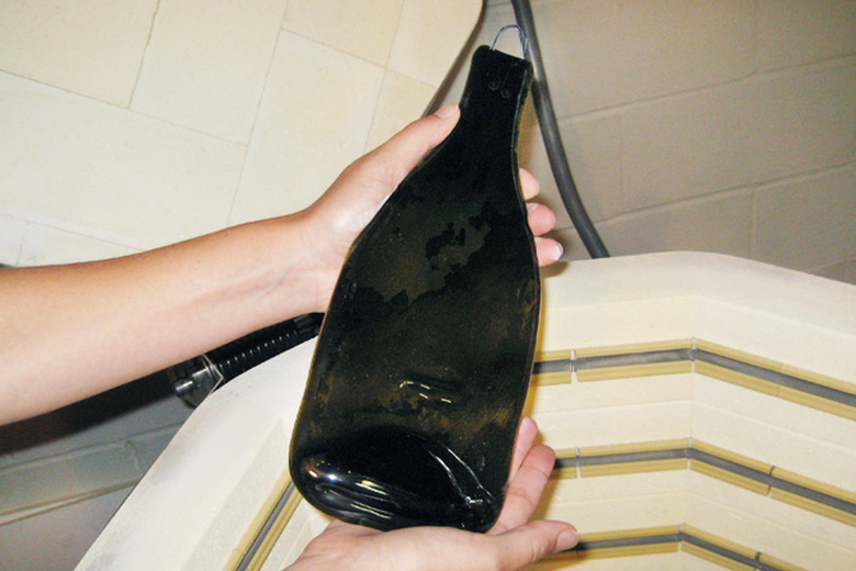 Remove the bottle from the kiln after it has cooled for at least 24 hours.