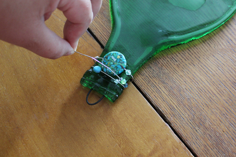Add decorative beads and wire to the neck of the bottle.