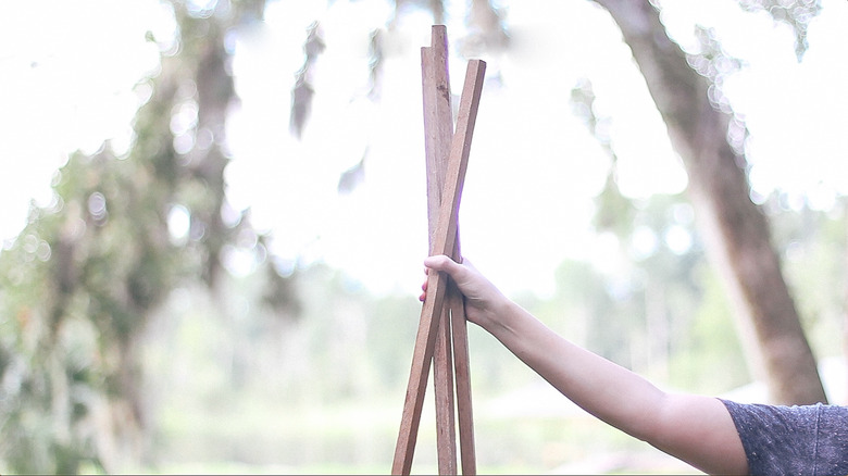 Joining three wood stakes together to form a cage