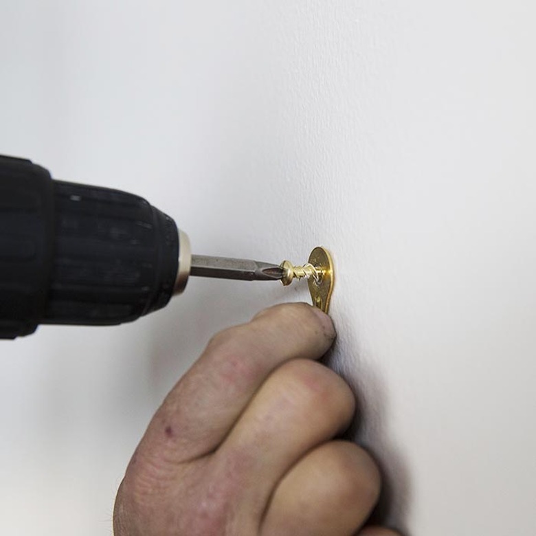 Wall anchor being attached.