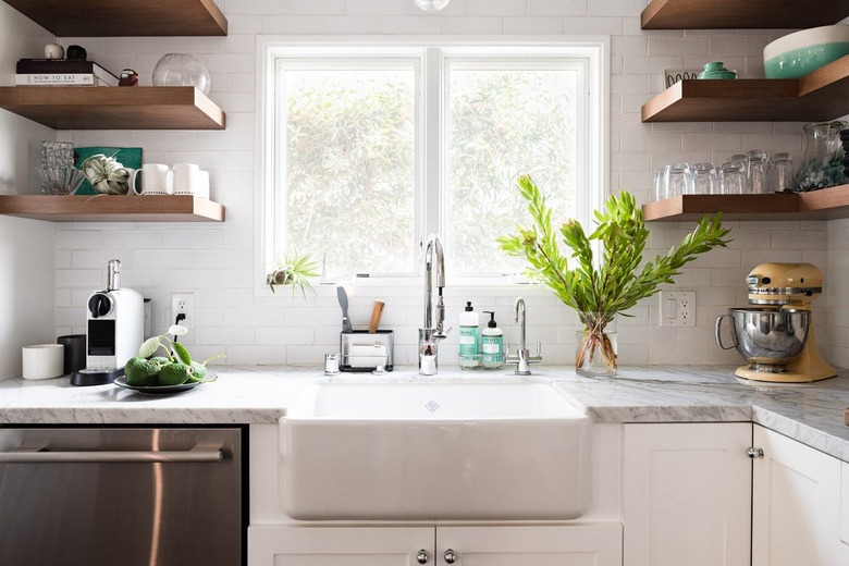 A kitchen faucet over a white apron sink
