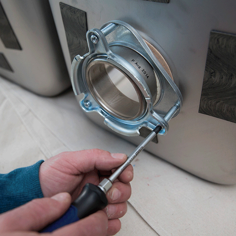 Installing a garbage disposal bracket.