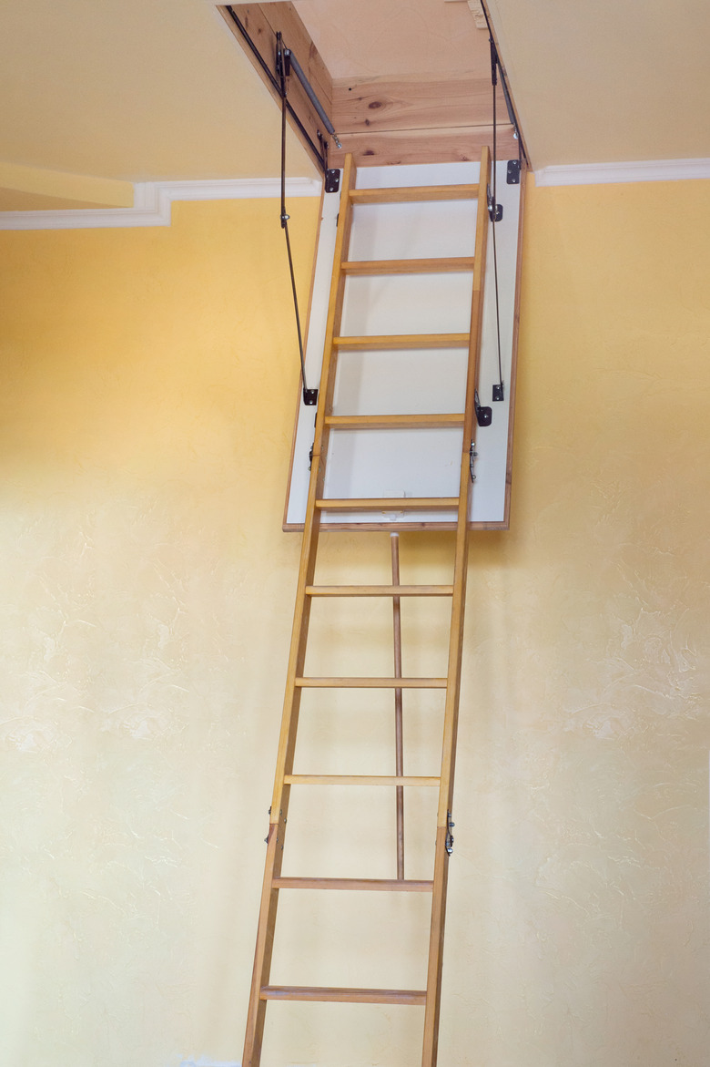 Wooden staircase to the attic in a modern house empty