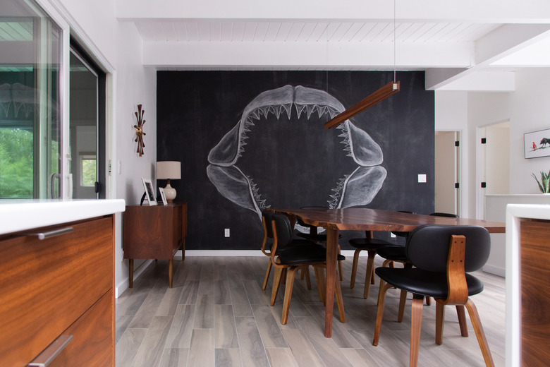 modern dining room with grey flooring and chalk wall