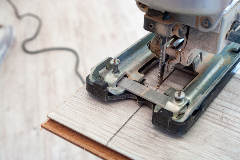 Electric jigsaw at work. Closeup.