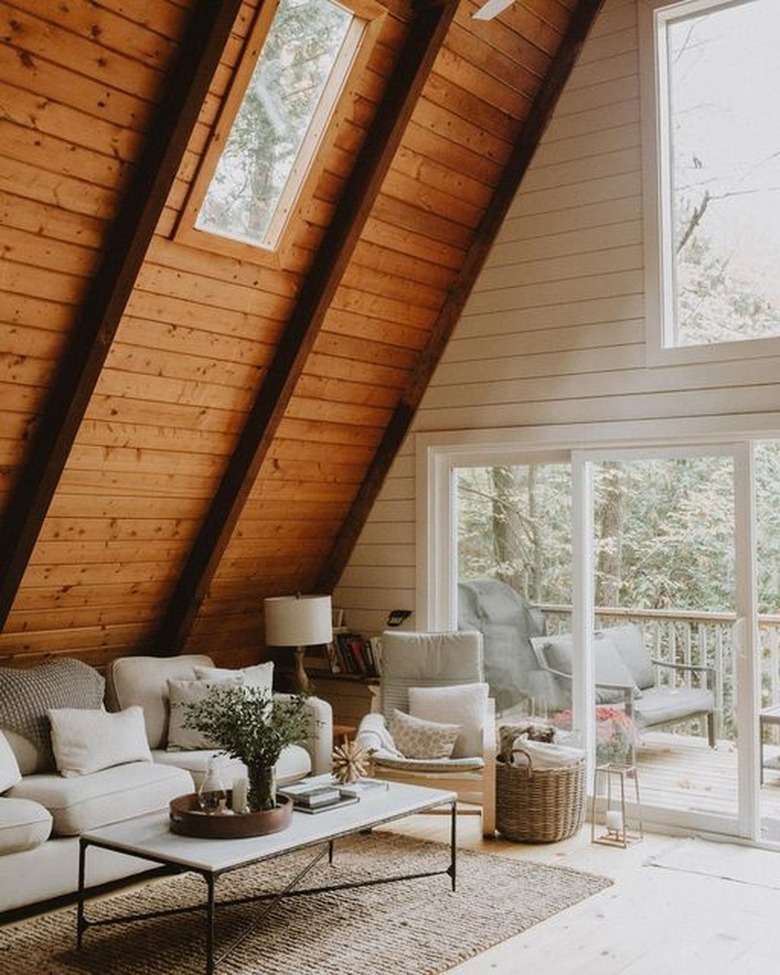 knotty pine living room walls with one white accent wall