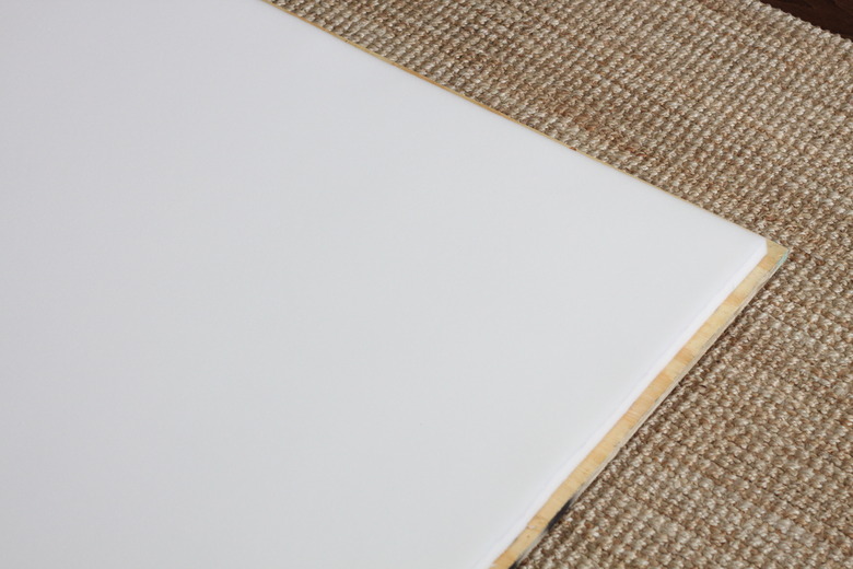 Plywood with foam piece adhered to it.