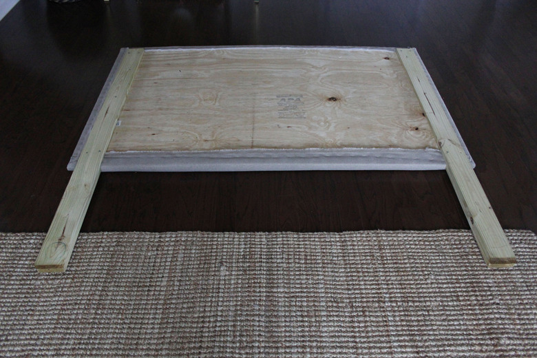 Wood boards screwed on to the back of the headboard portion