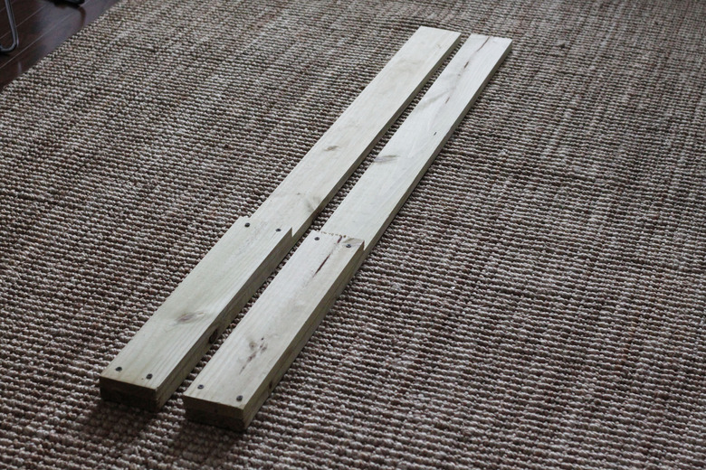 Two smaller wood pieces attached to the longer wood pieces.