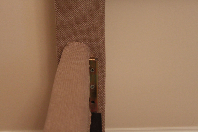 Screwing bed frame to the headboard.