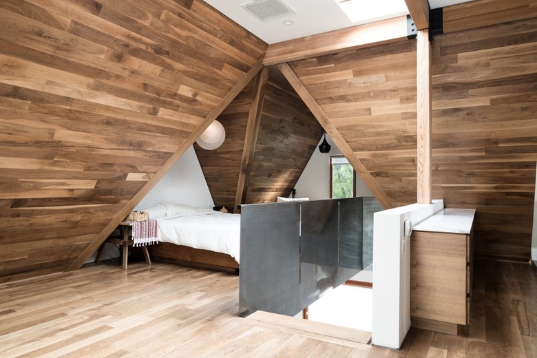 A bedroom with angular wood walls