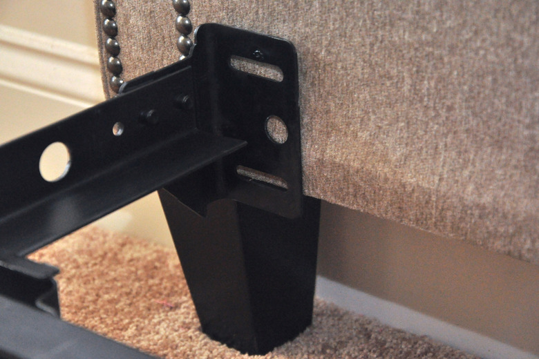 Headboard positioned against frame.