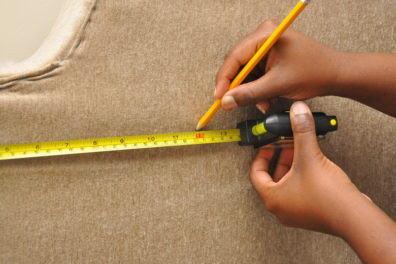 Measuring bracket locations on headboard.