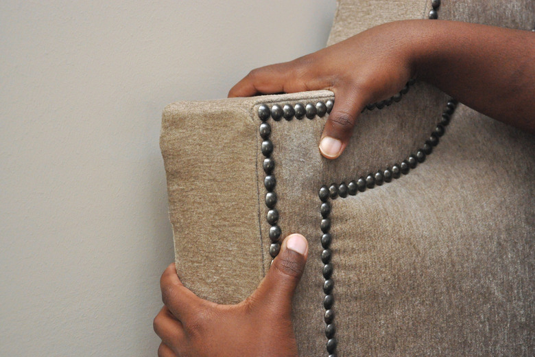 Headboard being positioned.