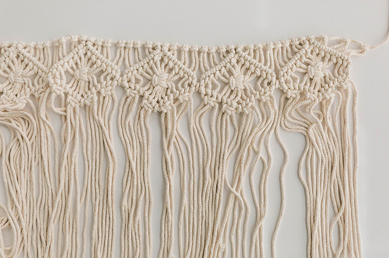 Saturate the macrame wall hanging with water.