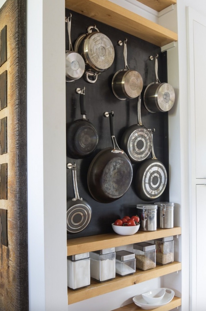 pots and pans hanging on wall