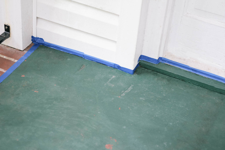 Concrete porch taped off with painter's tape along edges and sides