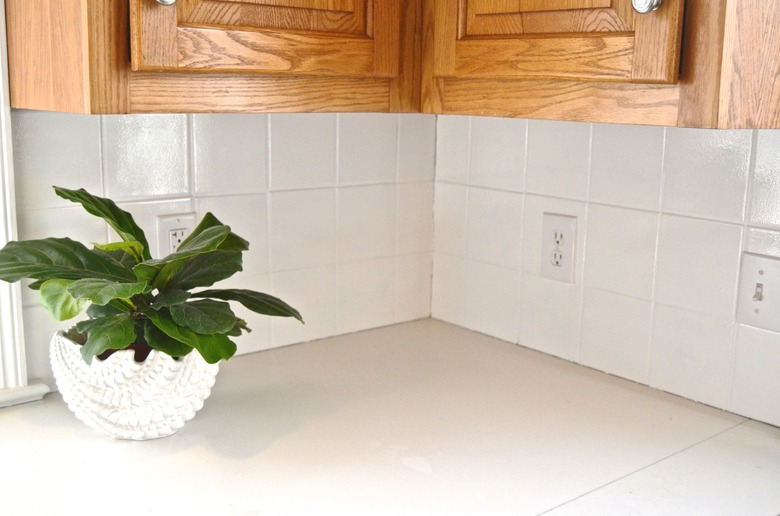 corner of kitchen with painted white tile