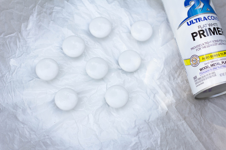 Cabinet hardware spray painted with white primer