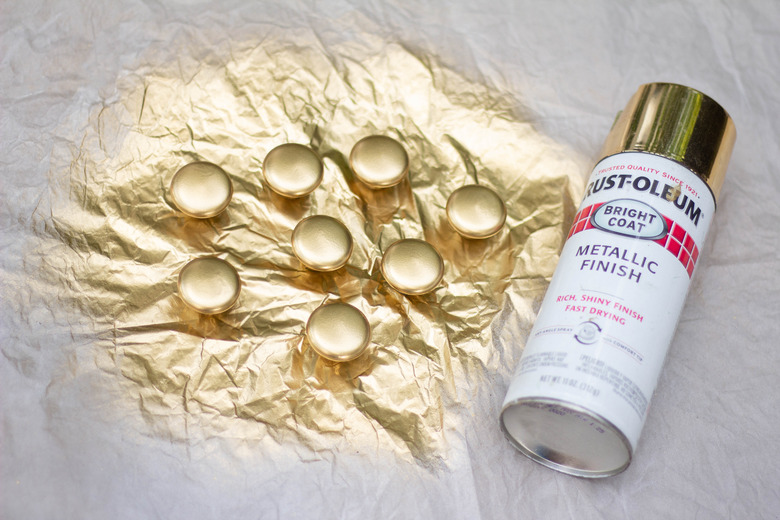 Cabinet hardware spray painted with gold paint