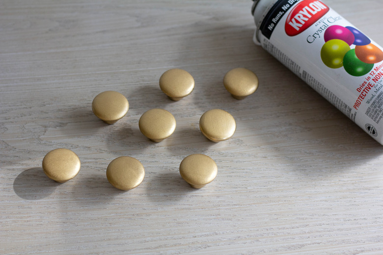 Brass cabinet knobs spray painted with clear satin topcoat