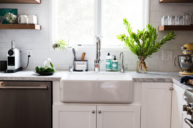 focus on farmhouse sink surrounded by subway tile