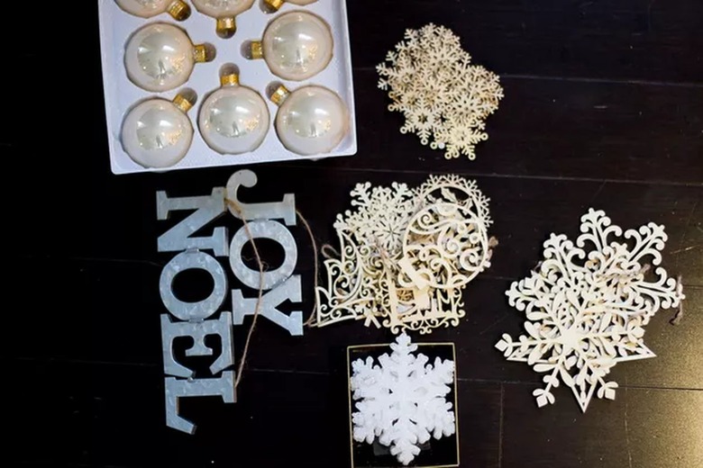 A series of holiday ornaments are displayed on the table