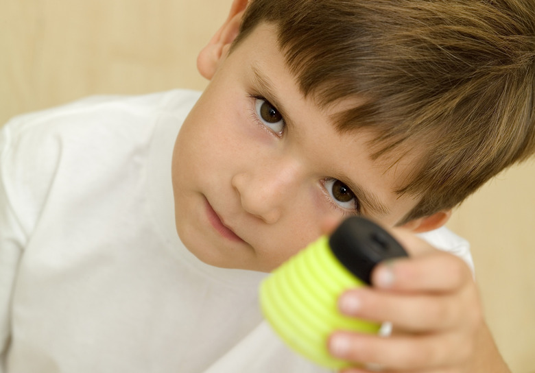 Young boy holding jar