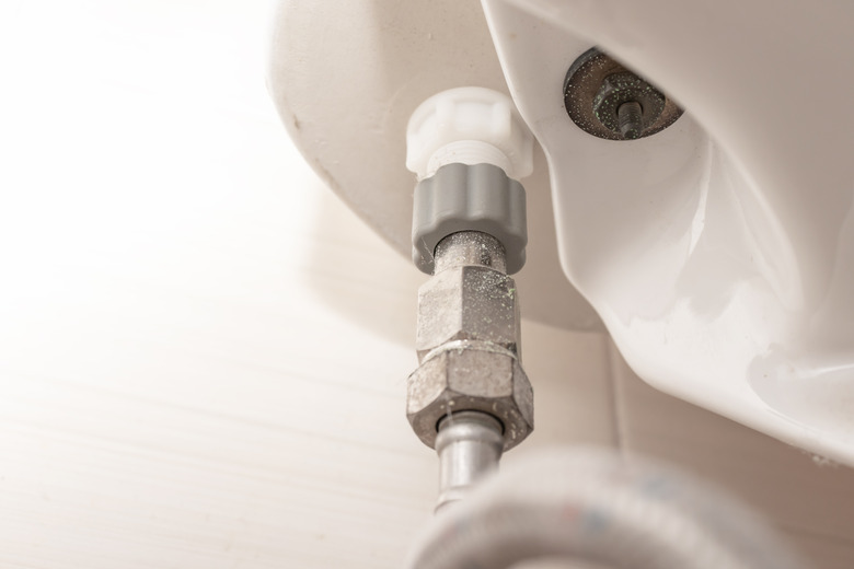 Water supply fitting of cistern tank of the toilet bowl at water closet close up