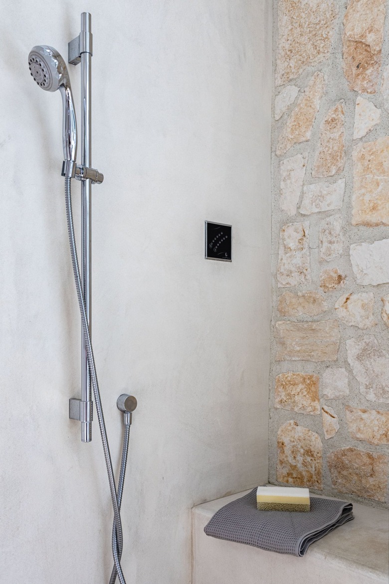 A shower with a rock accent wall