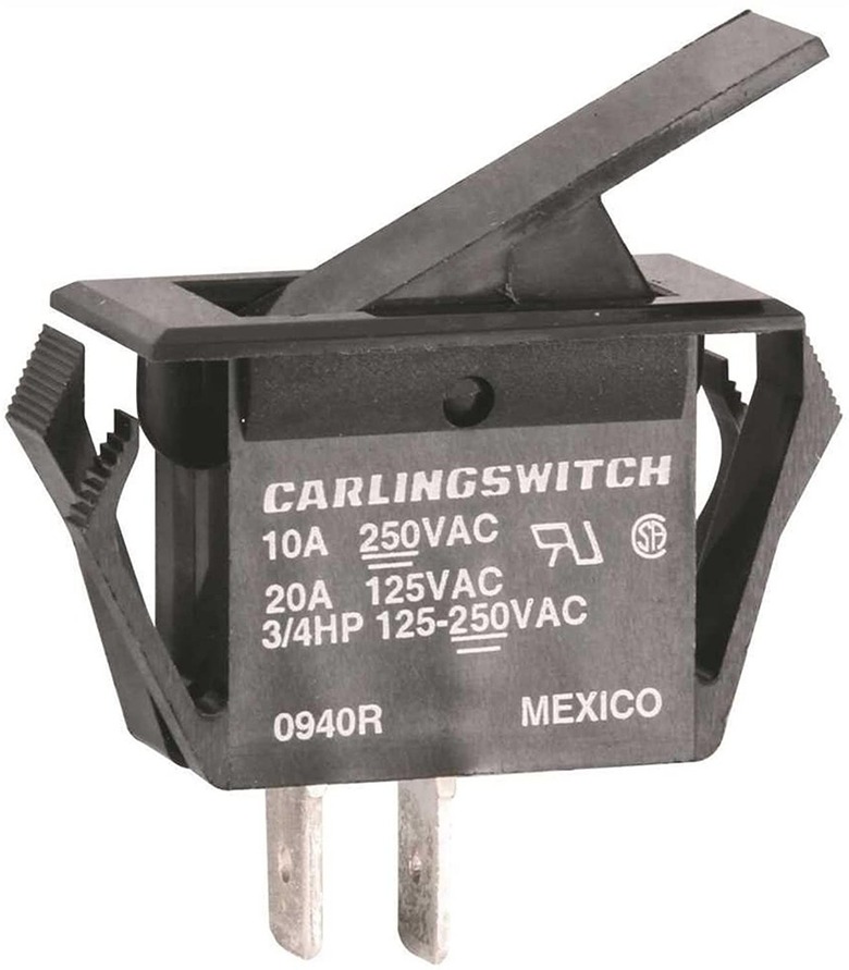 A close up of a furnace door safety switch part