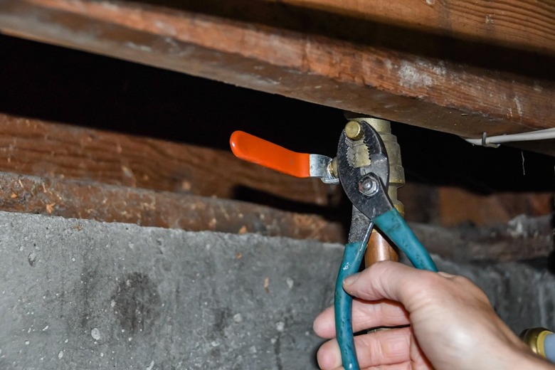 tightening sprinkler system shutoff valve bleeder cap with pliers