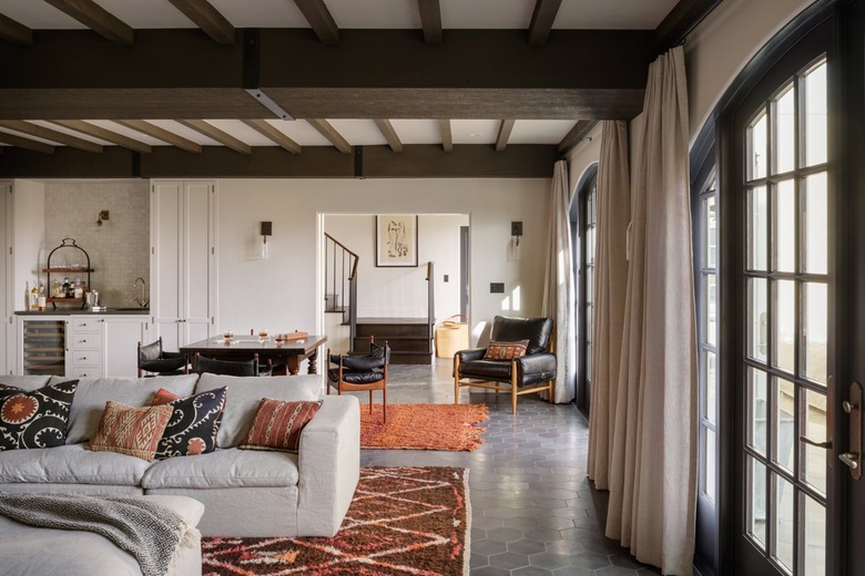 large living room with zones created from rugs.
