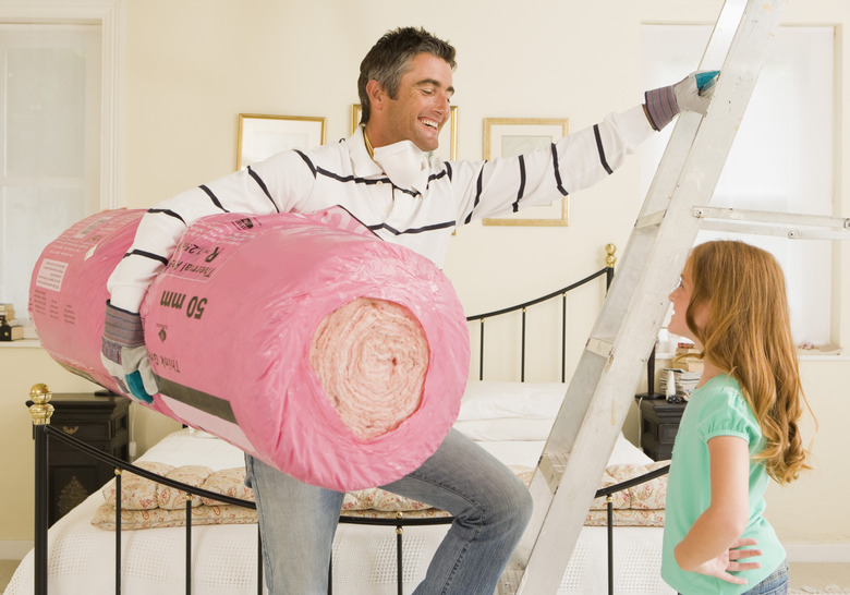 Man and daughter with bundle of roof insulation