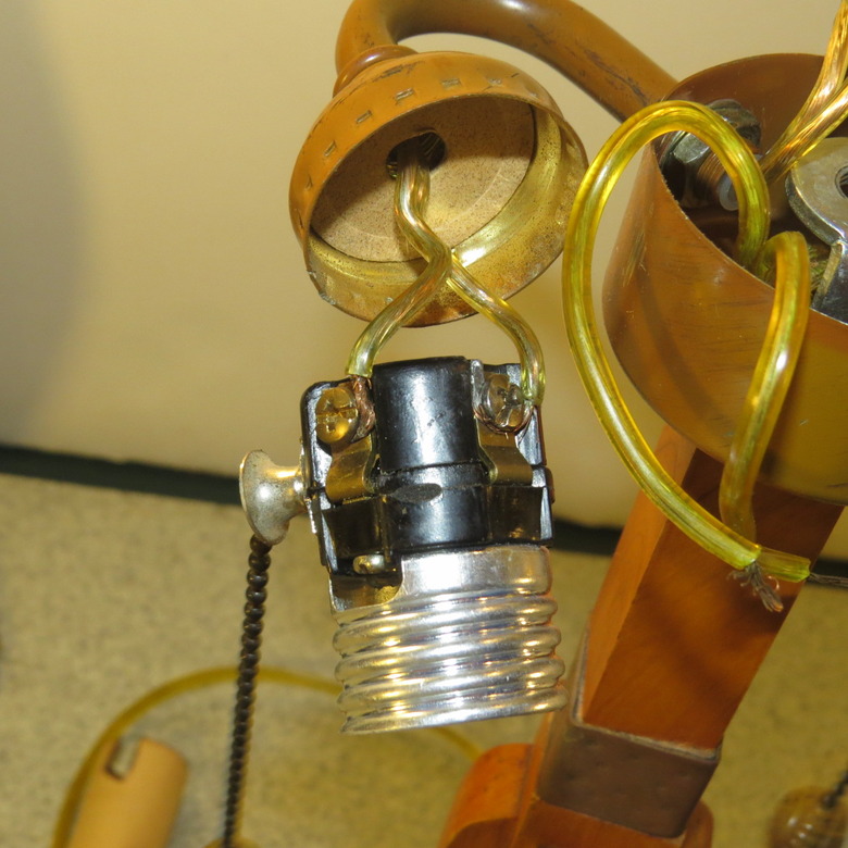 Detached light bulb socket with wires attached.