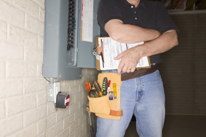 Man checking fuse box