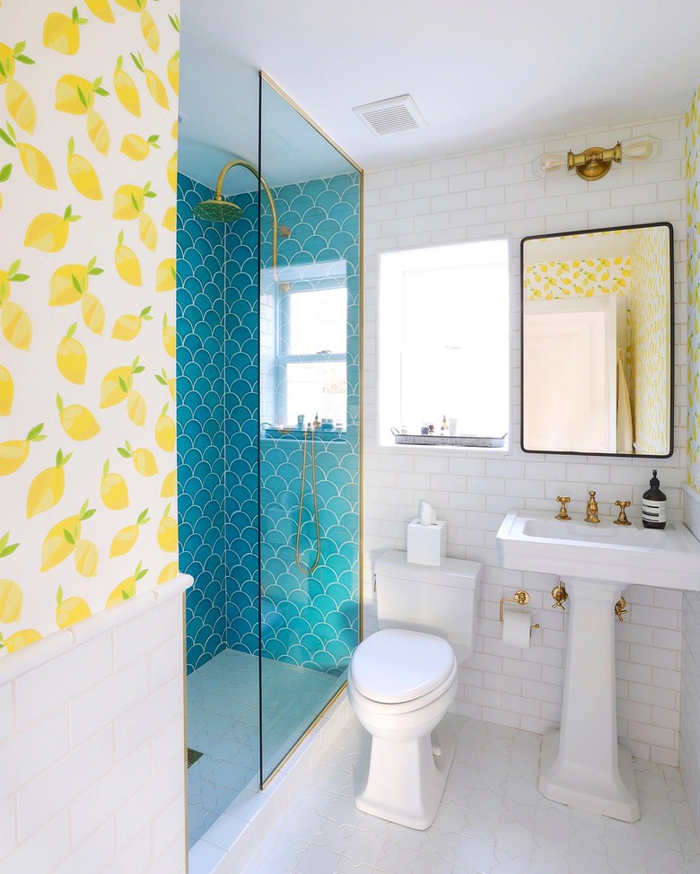 Blue scalloped walk-in shower with lemon wallpaper