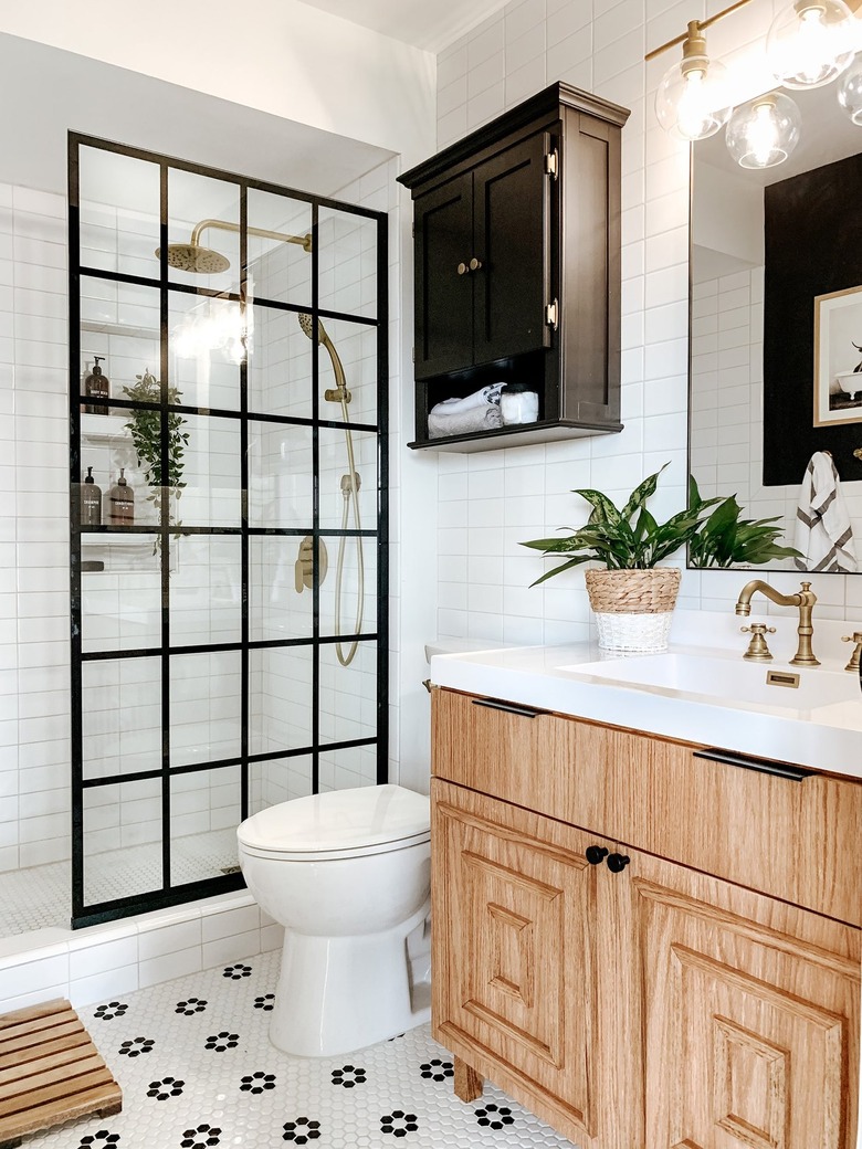 Black and white bathroom with flower penny tile and walk-in-shower