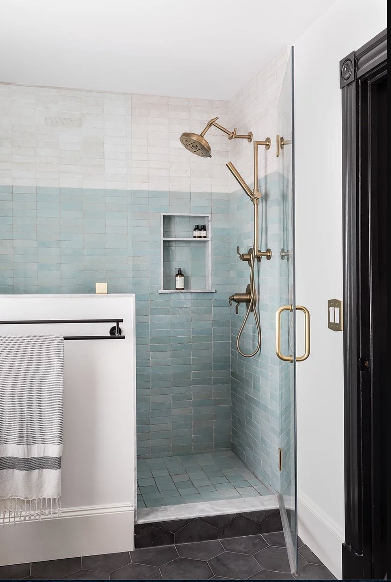Bathroom with walk-in shower and matte textured tiles.