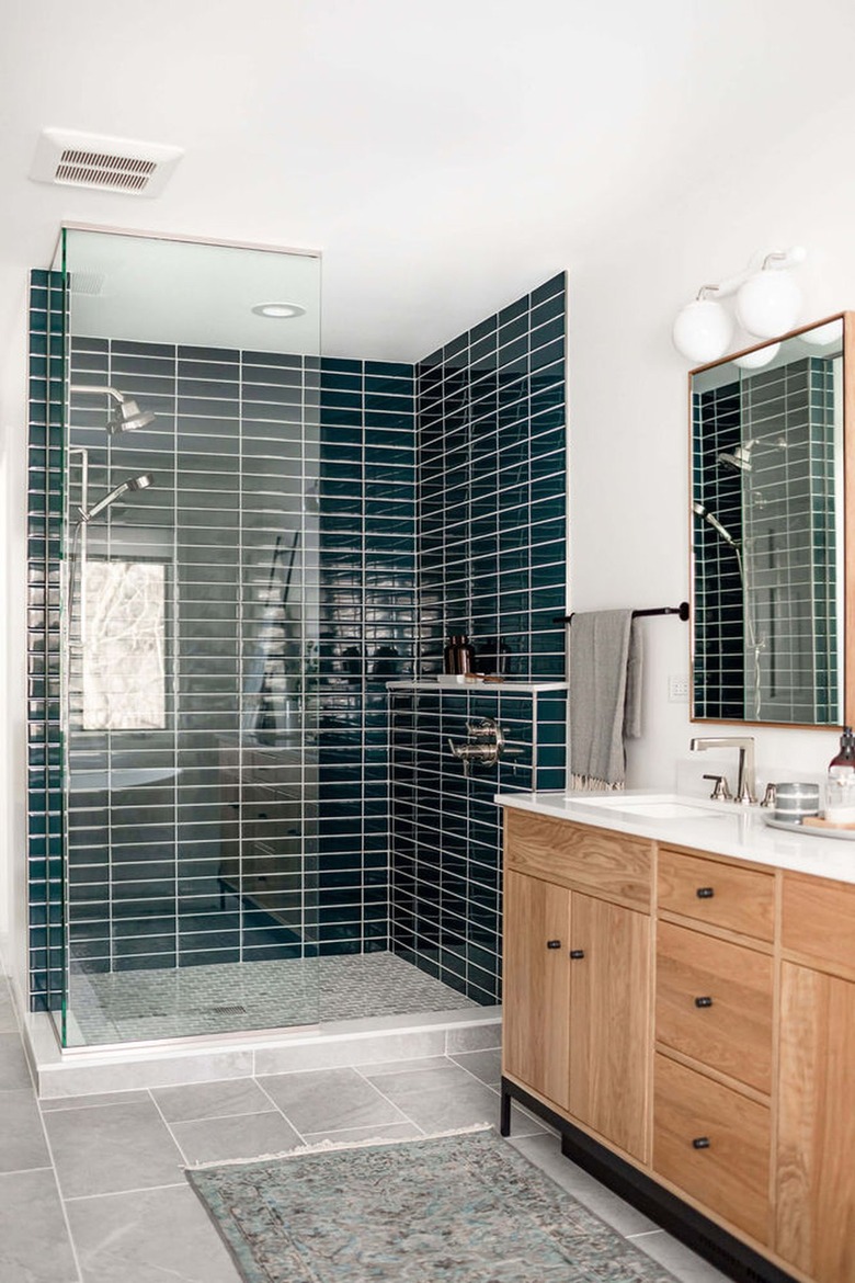 Minimalist bathroom with teal shower tiles