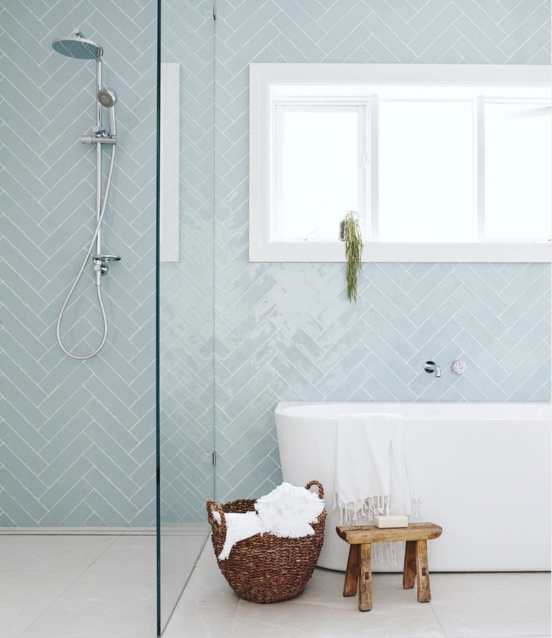 Walk in shower with blue glass tiles