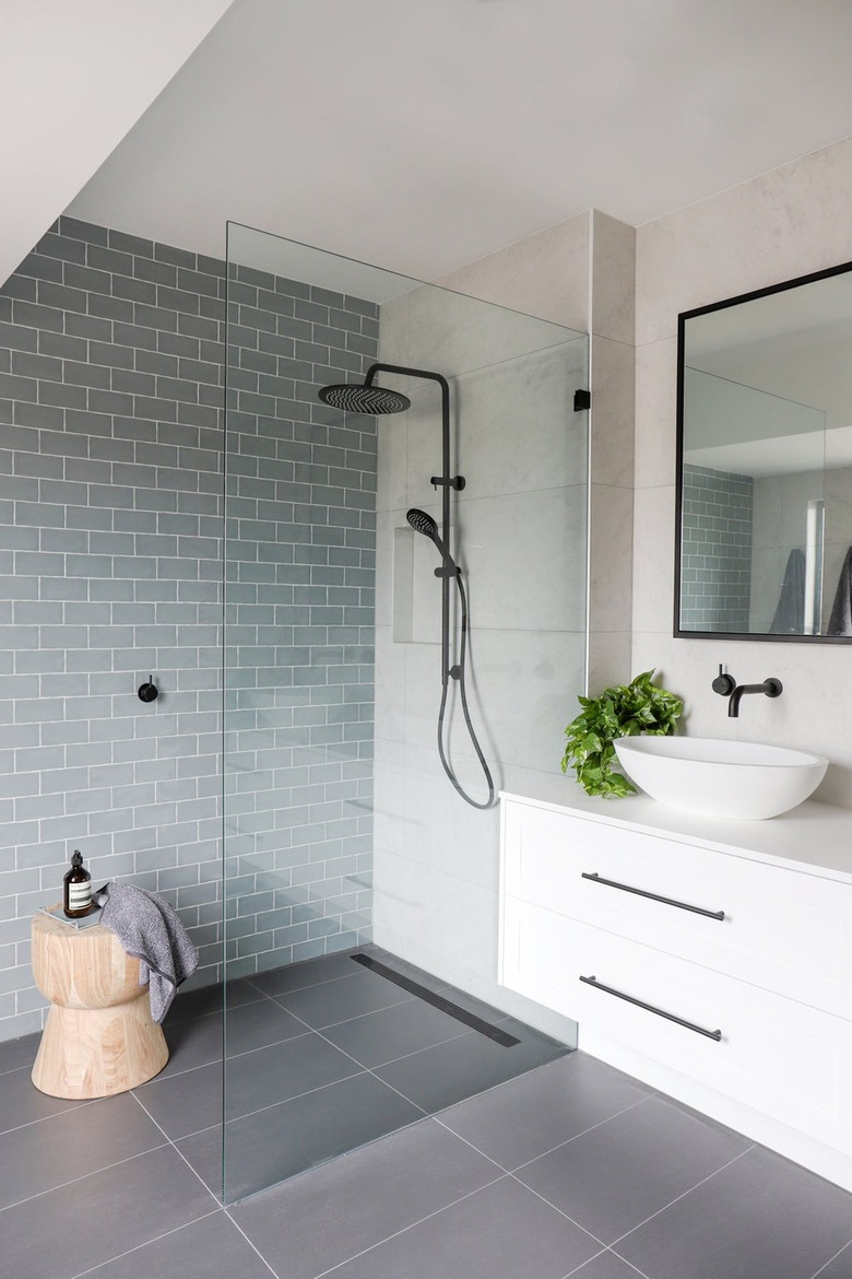Modern bathroom with blue tile in walk-in shower